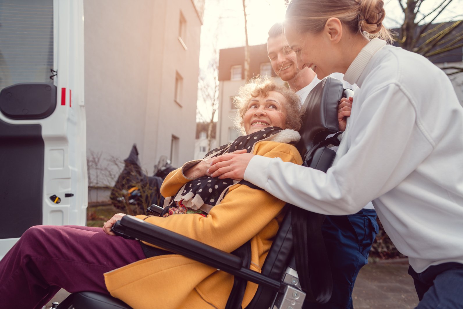 Senior Woman in Wheelchair Being Picked up by Transport Service